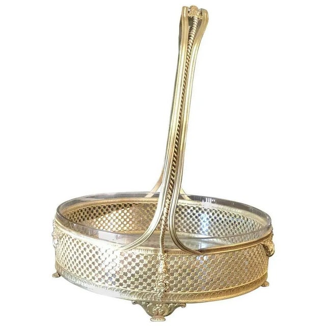 Polished brass handled basket. Cut-glass insert. Dimensions Width 11"Depth 8.75"Height 10"