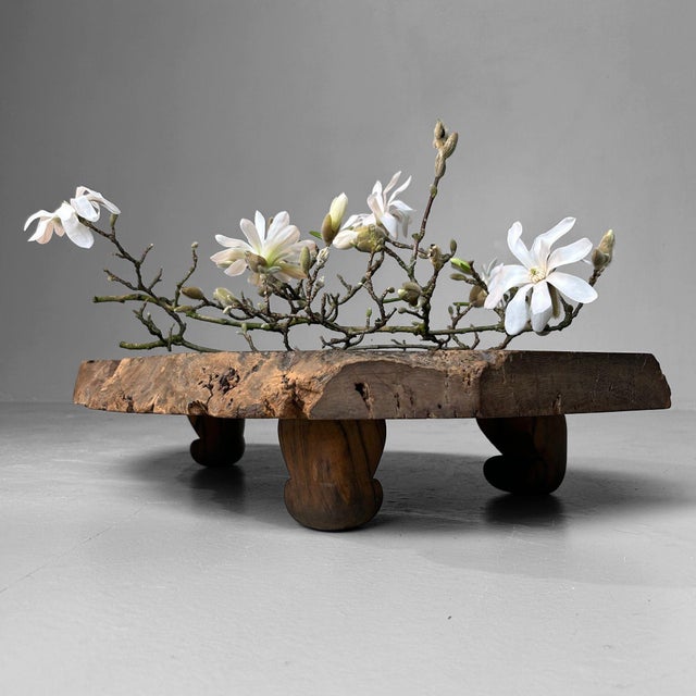 This unique Japanese table from the Meiji period is handcrafted from a single solid wood slab, bringing nature's pure...