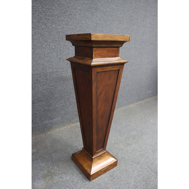 Pedestal column by Ethan Allen featuring a tapered, architectural form with a stepped base and molded top. Finished in a...