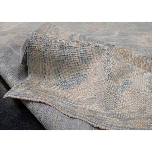 Turkish Oushak Rug Gray, Ivory & Blue Handwoven Rug 6' X 9'7" This handwoven wool rug is a beautifully crafted Turkish...