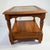 A timeless solid oak side table by Bassett Furniture, featuring a glass-inset top, turned spindle legs, and a lower...
