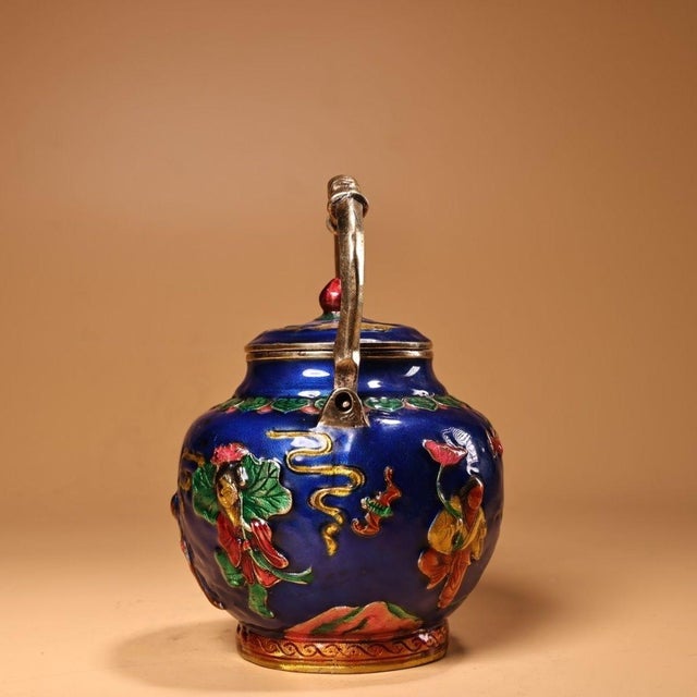 This is a striking and vibrant cloisonné enamel teapot, featuring intricate, multi-colored artwork. The body is covered in...
