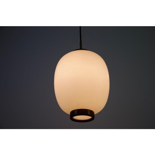 A striking pendant lamp designed by bent karlby for lyfa, denmark, in the 1960s. This elegant scandinavian modern fixture...