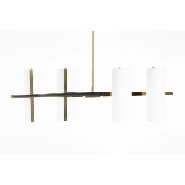 Pendant light in the style of Maison Arlus and Lunel Made in the sixties in France Black metal structure, 4 reflectors in...