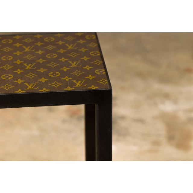 A small side table with Louis Vuitton leather top mounted on a custom metal base with cross stretchers. Immerse yourself...