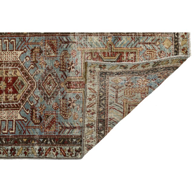 An exceptional late 19th to early 20th-century antique Heriz Serapi runner, showcasing a beautifully weathered, low-pile...