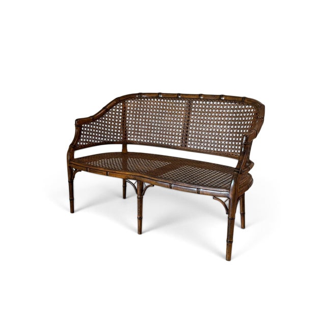 Elegant and distinctive, this Hollywood Regency-style settee features a beautifully crafted faux bamboo frame with an...