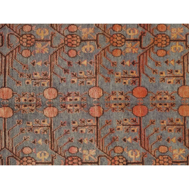 Woven in the 1920s, this spectacular antique rug from Khotan features an exemplary pomegranate pattern surrounded by...