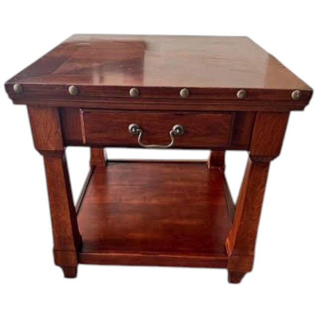 A rustic wooden farmhouse style end table featuring a beautiful parquet-pattern wood veneer top, a signature decorative...
