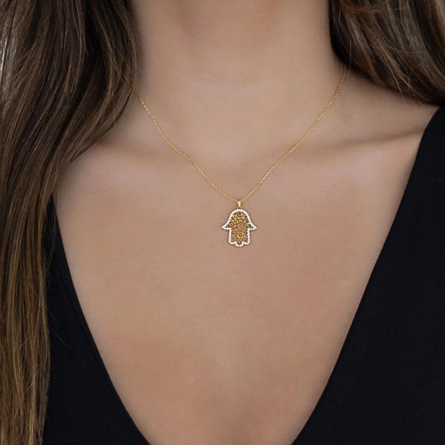 The Spiral Design Hamsa Gold & Diamond Necklace is not only a stylish accessory, but also holds deep meaning and...