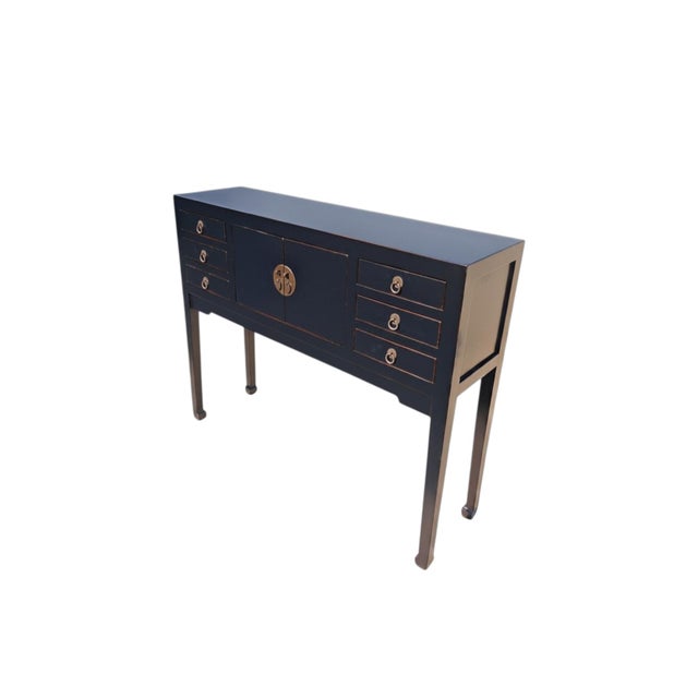 This antique wooden console table features features a central two-door cabinet for storage, with three stacked drawers on...