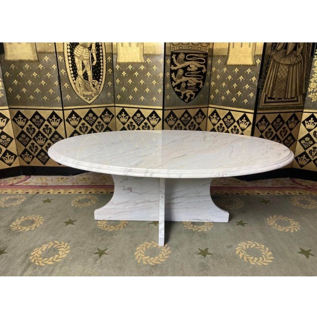 Beautiful oval coffee table entirely made of white Carrara marble with grey and pink veining, from Italian production of...