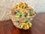 This Italian Capodimonte porcelain trinket box takes the form of a little flower basket, with hand-applied roses and...