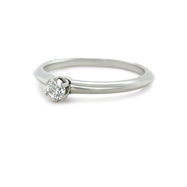 This elegant Tiffany & Co. solitaire engagement ring is crafted in platinum, showcasing a timeless and refined design...