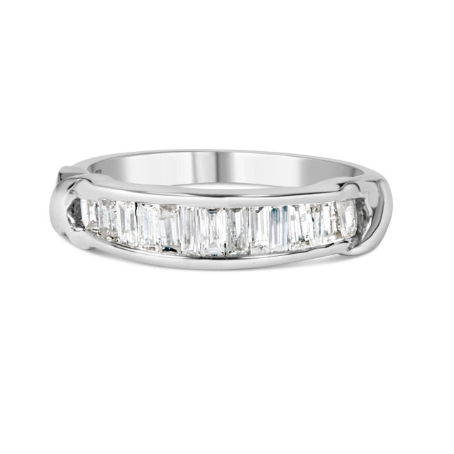Elegant and timeless, this rhodium-plated .925 sterling silver diamond band features 0.5 carat total weight of baguette...