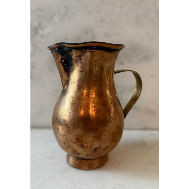Antique handmade hammered copper pitcher with a brass handle. Believed to be English circa late 1800s. **Condition Note -...