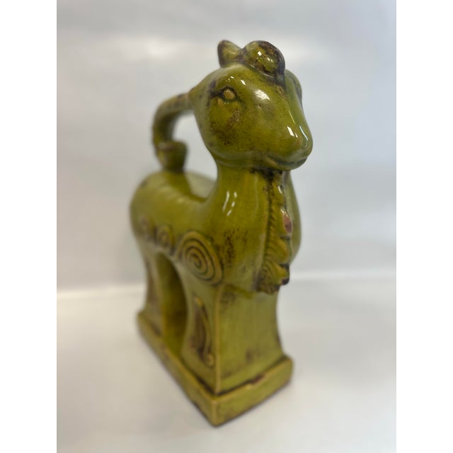 This is a very unique, large, ceramic porcelain decorative ram statue. The ram is standing on a rectangular base and is a...
