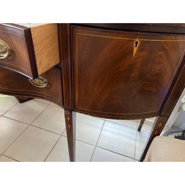 The Brass Gallery Mahogany Serpentine Front Federal Sideboard is an antique piece of furniture from the1960s, handmade...