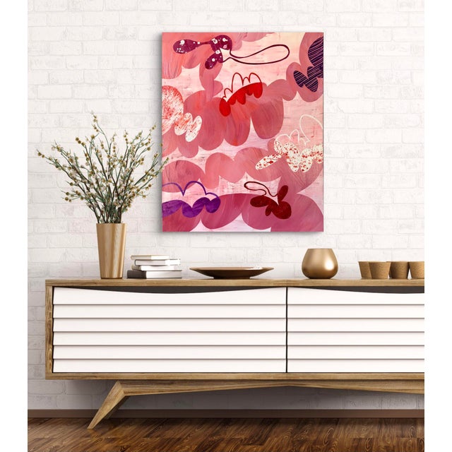 This pink and coral painting on canvas has pops of purple. There is plenty of texture with scrapings and splatters. The...