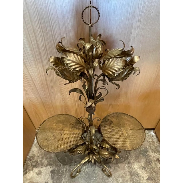 Mid-Century Modern Italian-style gilded metal floral floor lamp. This exquisite lamp features 7 ornate burnished gold...