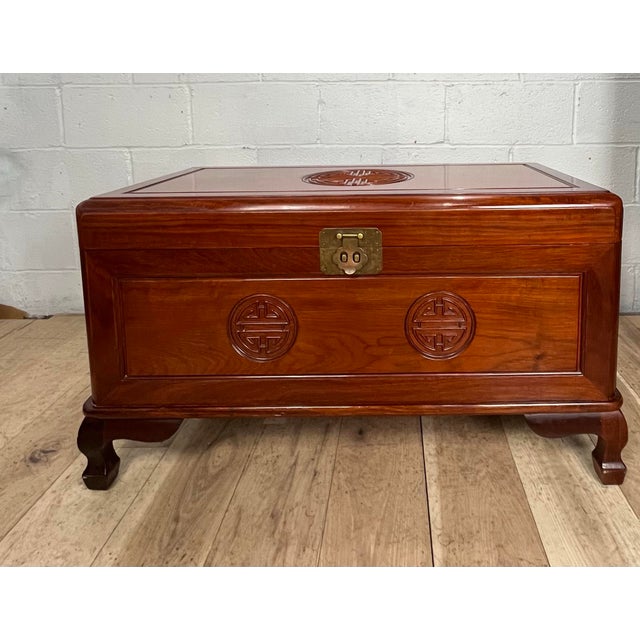A beautifully crafted Mid-Century Chinese Ming Revival blanket chest featuring a richly figured hardwood exterior and...