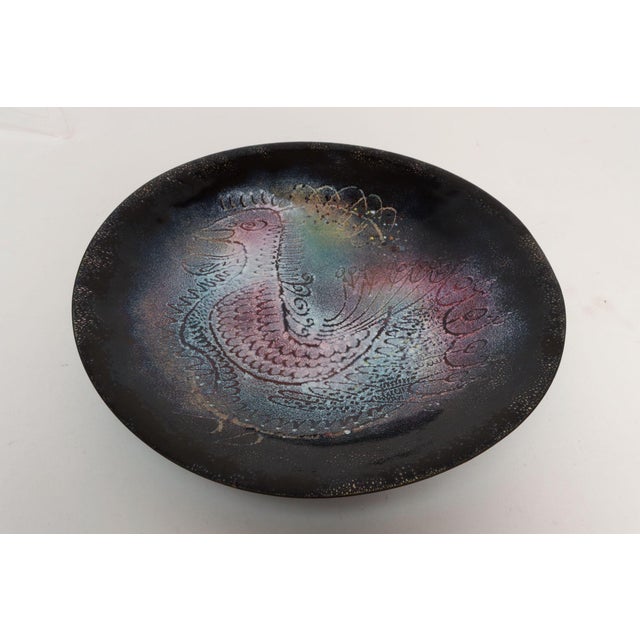 Enamel on copper decorative plate with central peacock/bird figure by renowned enamel artist, Arpad Rosti (b. 1909,...