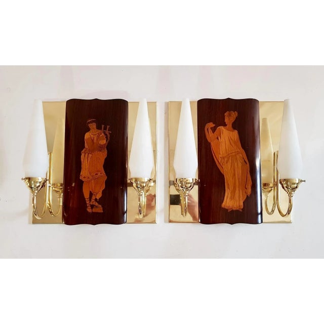 This pair of wall sconces in brass was custom designed and made by a local artisan to hold the marquetry panels by Andrea...