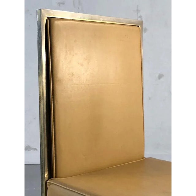 An elegant geometric chair, post-modernist, shabby-chic, bauhaus, square section metal structure with irregular and faded...