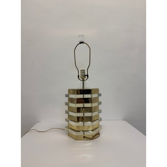 Stacked brass and lucite table lamp with lucite finial from the 1970s. *sold without lamp shade