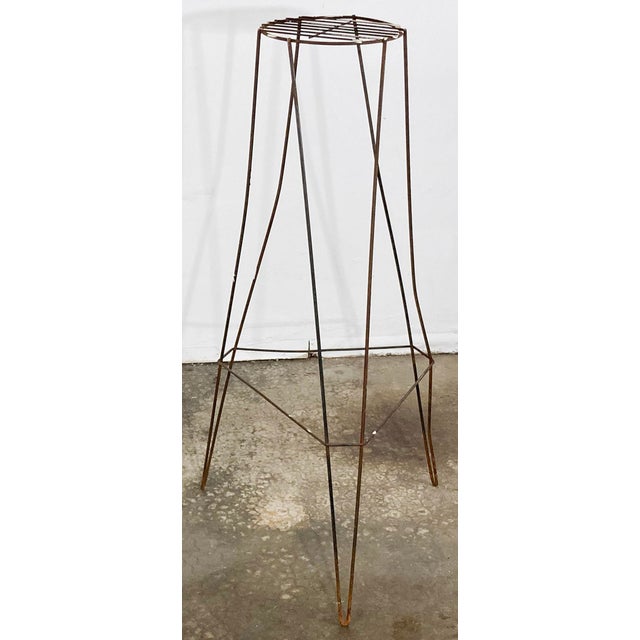 Vintage Mid-Century Modern iron plant stand featuring round slatted top surfaces atop tripod hairpin legs. Measures 17"W X...