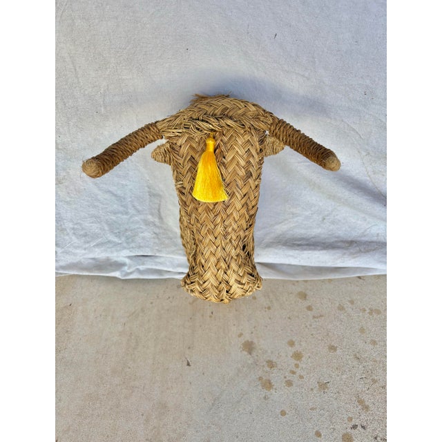 This Mid 20th Century Wicker Rattan Minotaur Bull Head Sculpture Wall Decoration was handcrafted by artisans in a small...