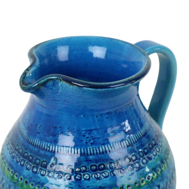 A stunning mid-century ceramic vase featuring a blue crackle glaze. This fantastic piece was designed by aldo londi for...