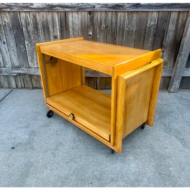 Vintage Mid-Century Modern serving cart by John Keal for Brown-Saltman of California, c. 1950's. Lower shelf unlocks and...