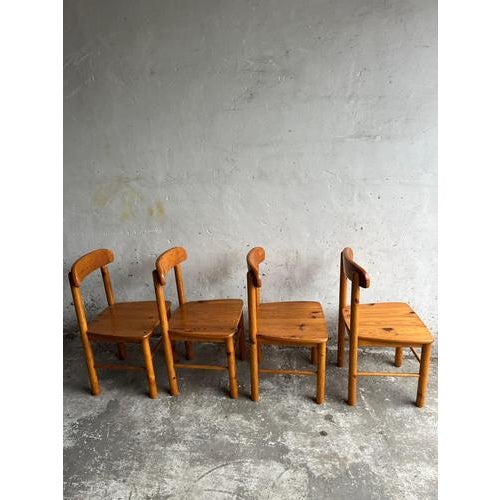 Set of four solid pine dining chairs from the 1970s, featuring a warm honey-toned finish and honest, timeless design....