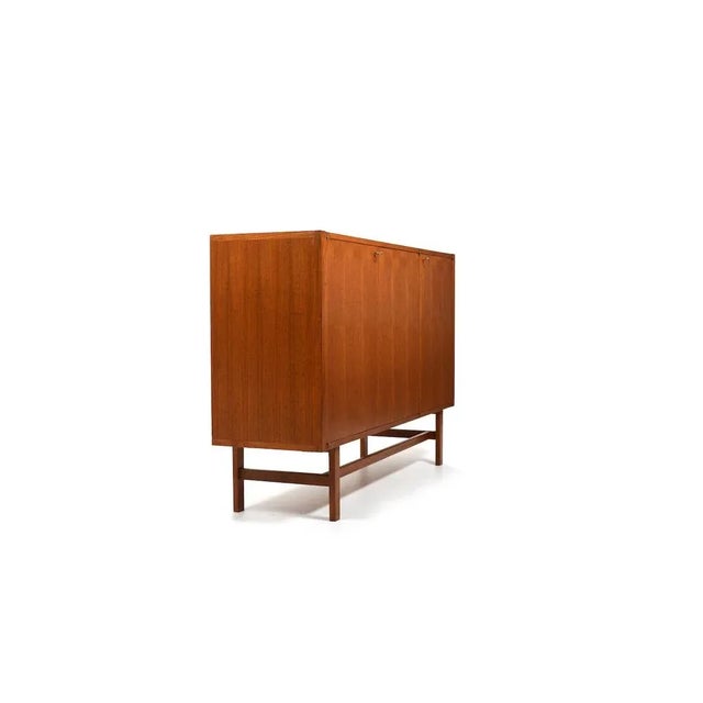 Minimalist Danish teak sideboard with three doors. Inside with shelfes and drawers. High danish quality production a.1960.