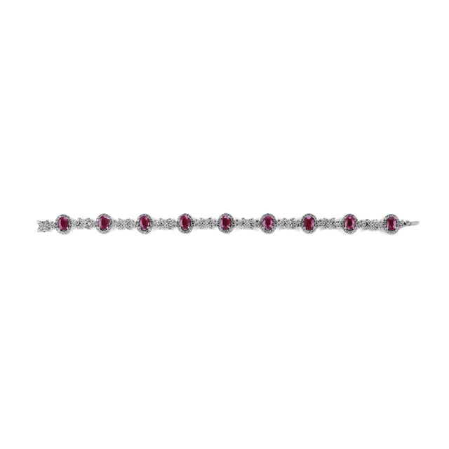 Exquisite natural diamond and ruby bracelet, by Alexander Beverly Hills. 14.06 carats total diamond weight. 9 oval rubies,...