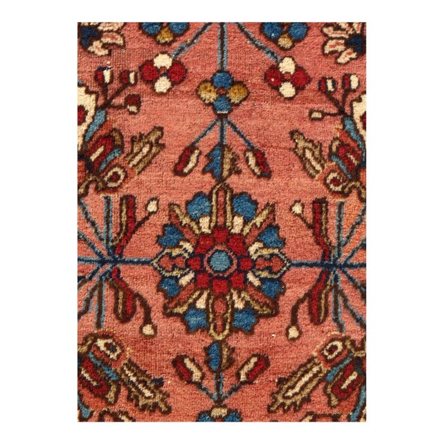 This is an antique handmade rug from the early 20th century. The piece was crafted from lamb's wool on a cotton foundation...