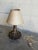 This charming ceramic table lamp features a textured brown base and tapered shade. The warm silhouette brings cozy...