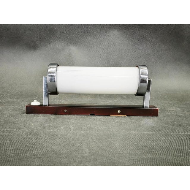 Original Bauhaus wall light manufactured in Czechoslovakia during the 1930s, executed in chrome-plated metal, lacquered...