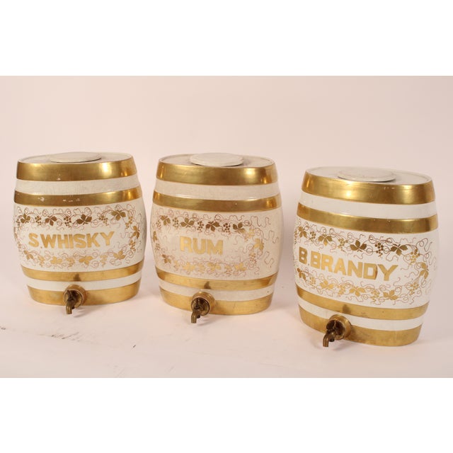 Set of 3 Staffordshire spirit dispensers, circa 1900. Set includes whisky, rum and brandy dispensers. Each dispenser with...