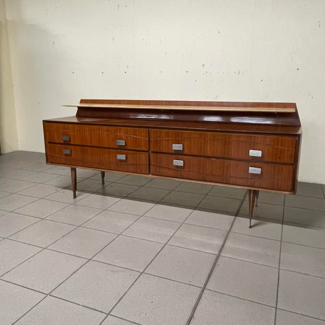 A refined 1950s sideboard with a slender structure, typical of Italian modernism from that period. Crafted from fine...