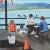 Blue Coastal Pier W/People, Seagulls With an Ocean and Sandy Beach Landscape in Background Oil Painting For Sale - Image 8 of 9