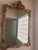 Stunning oversized wall mirror featuring an ornate Rococo Revival frame with elaborate acanthus leaf carvings, shell...