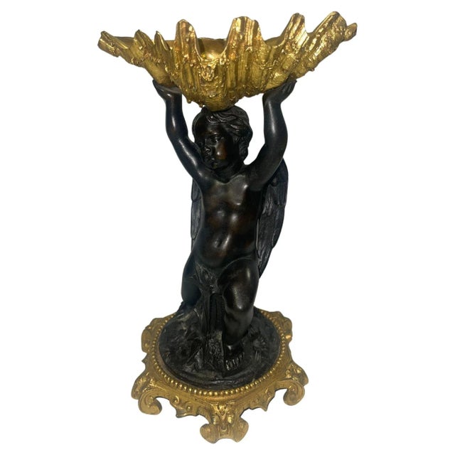 This elegant pair of 19th-century French gilt bronze garnitures features shell-form bowls gracefully supported by finely...