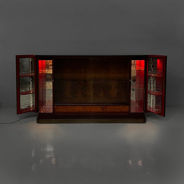 Italian Art Deco bar cabinet with lamp in wood, mirror and glass, 1930s Bar cabinet with wooden frame. Two side...