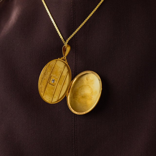 This elegant Victorian locket necklace is a beautifully preserved jewel from the 1900’s, accented by an old mine cut...