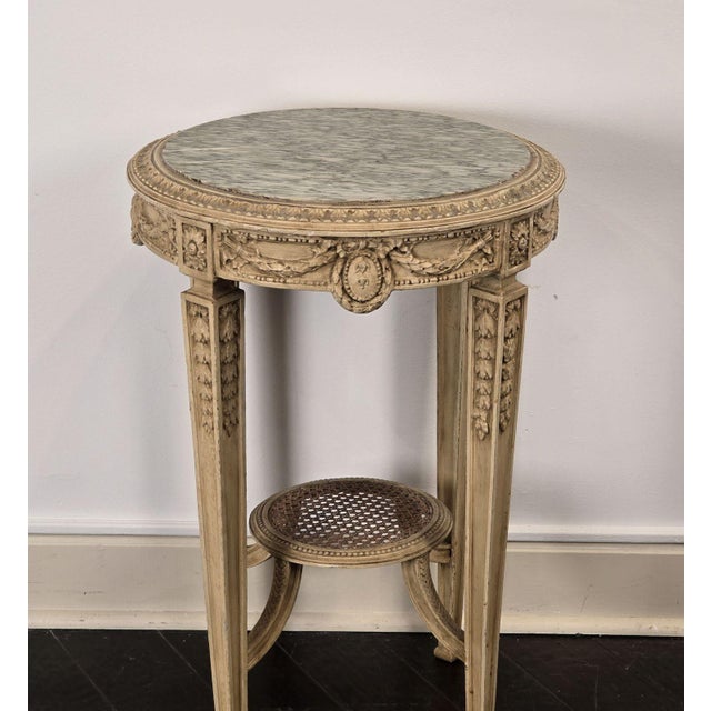 A well carved painted Louis XVI–style gueridon (small round table) inset with marble. Made in Sweden, circa 1900. The...