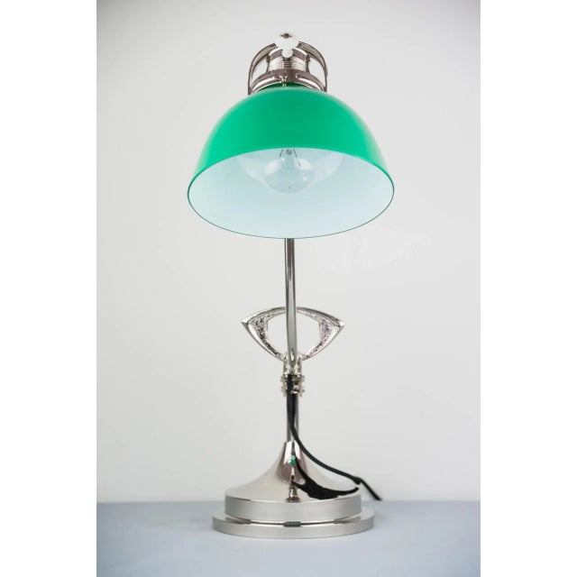 This Art Deco swiveling nickel table lamp dates from the 1920s and retains its original glass shade. European Plug (up to...