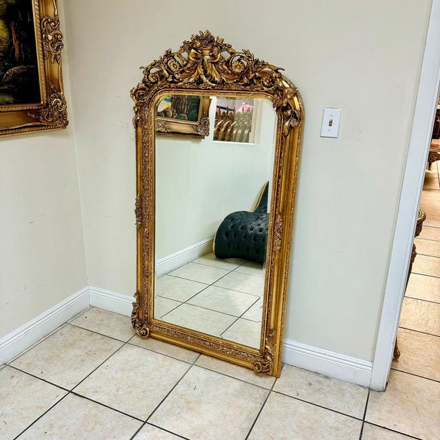 This French style gold floral floor mirror is a luxurious statement piece that combines exquisite craftsmanship with...