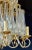 A finely cast gilt bronze tiered chandelier having large and impressive crystals. This one of a kind lighting fixture is...